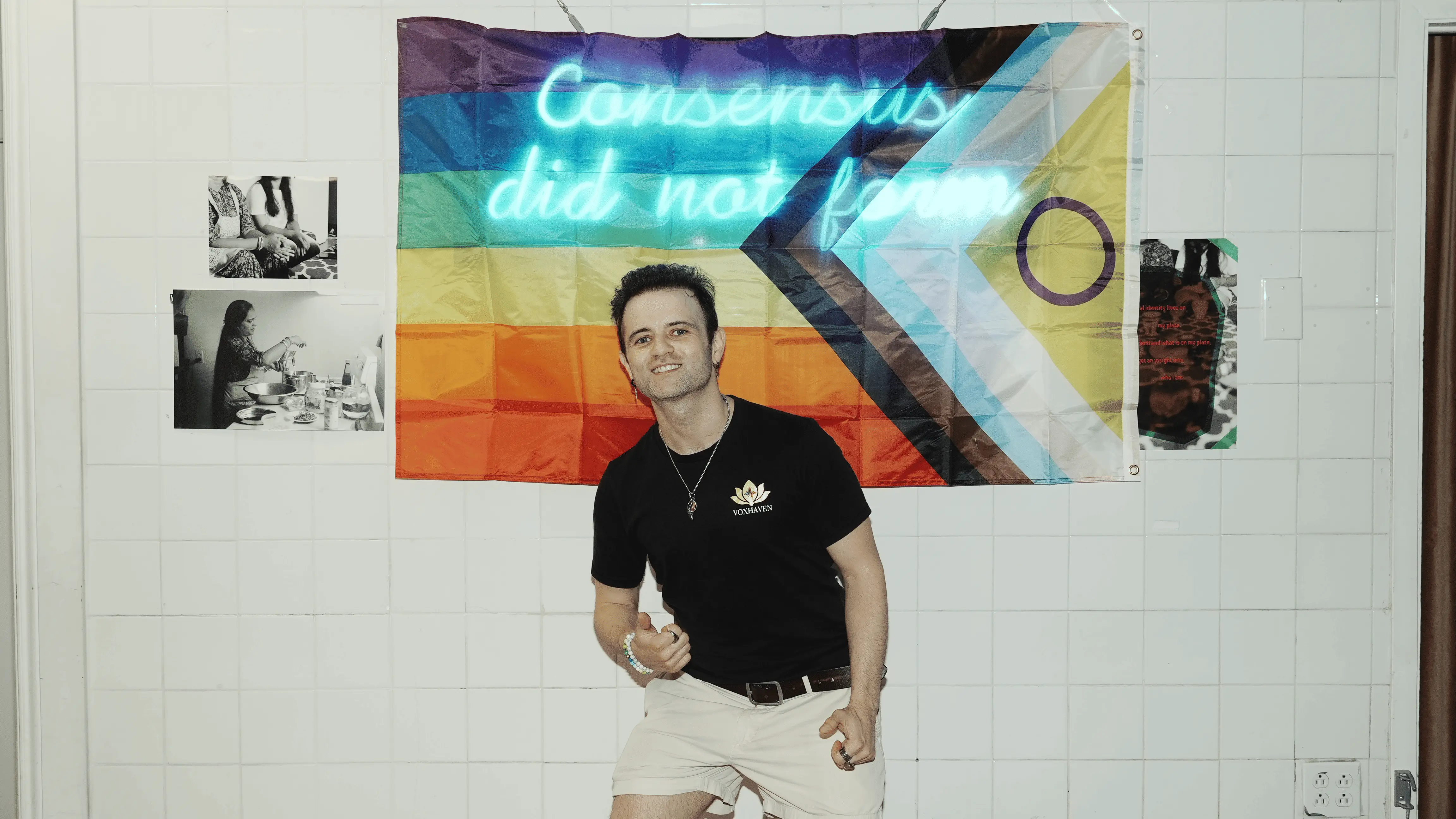 Yazan, founder of VoxHaven, smiling in front of a Progress Pride flag
